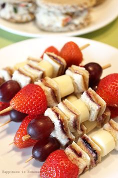 fruit and cheese skewers on a white plate