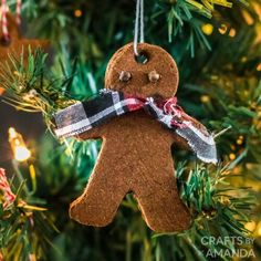 a gingerbread ornament hanging from a christmas tree