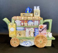 a ceramic figurine of a tea cart