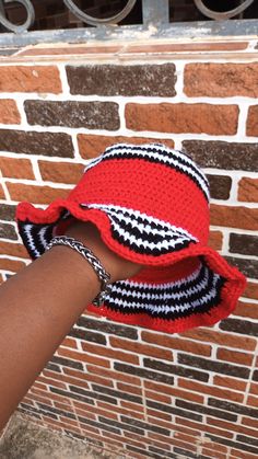 a person wearing a red hat with black and white stripes