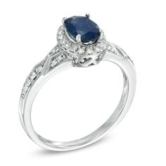 This 7.0 x 5.0mm oval blue sapphire and 1/5 ct. t.w. diamond ring is set in sterling silver. Custom made to fit your ring size, sterling silver rings cannot be resized after purchase. Oval Sapphire Ring In White Gold With Diamond Accents, Oval Sapphire Ring With Diamond Accents In White Gold, Oval White Gold Sapphire Ring With Diamond Accents, Oval Diamond Ring With Lab-created Sapphire And Diamond Accents, Blue Oval Diamond Ring With Polished Finish, Oval Blue Diamond Ring With Polished Finish, 14k White Gold Blue Diamond Ring With Polished Finish, Oval Sapphire Ring With Diamond Accents, Fine Jewelry, Oval Sapphire Ring With Diamond Accents For Anniversary