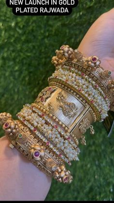 a person is holding several bracelets in their hand with the caption new launch in gold plated rajwada