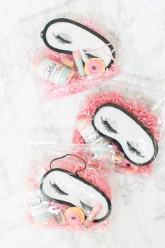 three bags filled with fake eyelashes on top of a marble countertop next to each other