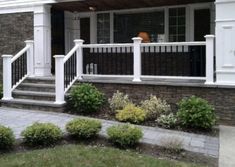 a house with white railings and stone steps