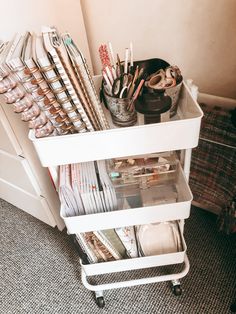 a white cart filled with lots of office supplies