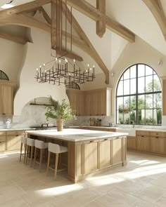 a large open kitchen with an island in the middle and lots of windows on both sides