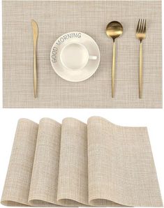 the place setting is ready to be eaten with goldware and silverware on linen napkins