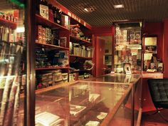 the inside of a book store with many books on shelves and a black chair in front of it