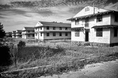 black and white photograph of an abandoned house