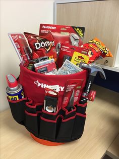 a red and black tool bag filled with tools on top of a wooden countertop