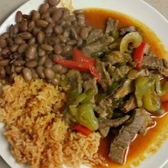 a white plate topped with rice and beans