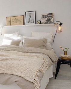 a bedroom with a large bed and white walls