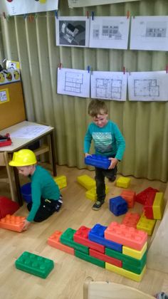 two children playing with blocks in a classroom