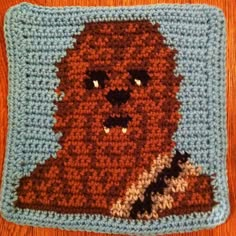 a crocheted square with an image of a bear on it