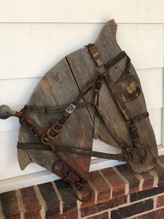 a wooden horse head mounted to the side of a building