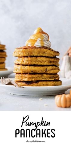 a stack of pumpkin pancakes with whipped cream on top and the title overlay reads, pumpkin pancakes