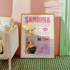 a pink and green room with a poster on the floor next to a white chair