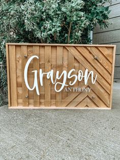 a wooden sign with the word grayson on it