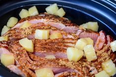 ham, pineapples and potatoes in a crock pot with seasoning on top