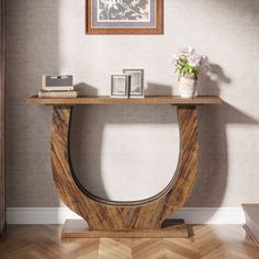 a wooden table sitting on top of a hard wood floor next to a vase filled with flowers