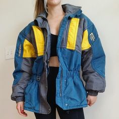 Incredibly Warm Vintage Ski Club Jacket! Mens Size Medium. Model Is Women's Medium Wears As Cozy Oversized Hip Winter Jacket. Comes With Hide Away Hood. 1-800 -Ski Detail On Back Urban Yellow Outerwear For Outdoor, Vintage Yellow Windbreaker For Winter, Retro Yellow Outerwear With Pockets, Yellow Winter Windbreaker For Outdoor Activities, Retro Yellow Windbreaker For Winter, Blue Sporty Ski Season Outerwear, Blue Sporty Outerwear For Ski Season, Sporty Blue Outerwear For Ski Season, Blue Ski Season Outerwear With Pockets