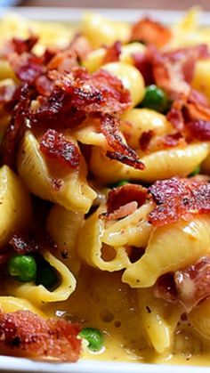 pasta with bacon and peas on a white plate