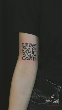 a person with a tattoo on their arm that says the best is yet to come