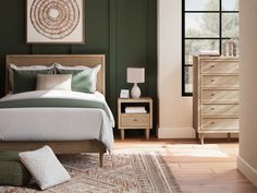 a bedroom with green walls and white bedding