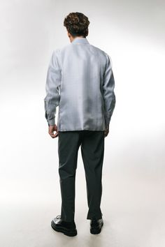 Elevate your wardrobe with The Mestizo Jose Men's Barong Tagalog in light gray, expertly crafted from luxurious cocoon silk. This modern interpretation of the classic Filipino garment features a light gray lining and blends hand- and machine-woven embroidery for a sophisticated blend of contemporary and traditional aesthetics. Intricate diamond-shaped patterns symbolize "sinag" (rays of light), reflecting transparency and clarity in Filipino culture, while captivating floral swirls add to its al