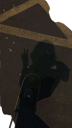 the shadow of a skateboarder is on the ground