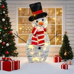 a lighted snowman in front of a house