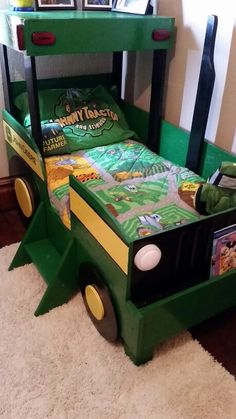 a child's bed made to look like a green school bus with yellow wheels