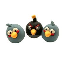 two angry birds are sitting next to each other on the same object as another bird