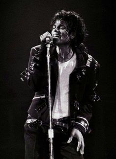 michael jackson performing on stage with his microphone