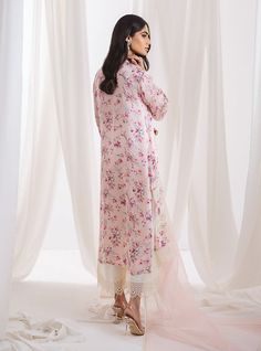 A sophisticated powder pink floral suit, this ensemble exemplifies grace features a soft, pink fabric adorned with subtle, intricate floral prints that provide a gentle contrast, imbuing the piece with a spring-like freshness. The standout feature is the meticulous white hem embroidery, which traces the borders with fine, elegant detailing. Complementing with fine organza dupatta. This suit is ideal for occasions making it a perfect choice for formal events or stylish social gatherings. Shirt: P Feminine Floral Print Wedding Sets, Spring Pink Sets With Floral Embroidery, Pink Floral Embroidery Sets For Spring, Spring Floral Embroidered Pink Sets, Spring Silk Sets With Floral Print, Pink Silk Sets For Spring, Elegant Pink Lawn Suit With Floral Print, Elegant Pink Lawn Suit With Floral Embroidery, Elegant Pink Floral Print Lawn Suit