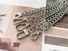 CURB CHAIN Purse Strap, Luxury Crossbody Strap, Handbag Replacement Chain , Silver Chain Strap, Purse Handbag Charm, Stainless Steel Chain Fashion design NK curb shape chain strap for your purse, handbag, crossbody shoulder bag, clutches, wallet, and many of your favourite designer bags. Come with clasps that are ready to link to your bag.  These luxury chains are a practical accessory for women or girls to carry bags easily while traveling, shopping and other activities.  We assure you that our products are not made of aluminium or iron metal that are sold by most retailers. Our chain straps are unique as it is one-of-a-kind solid high-quality polished stainless steel chain, which results in long-lasting durability.  PRODUCT ● DETAILS ▶Material: Stainless Steel Chain, Stainless Steel Clas Wallet Chains, Silver Bag, Favorite Purse, Chain Diamond, Chain Purse, Silver Bags, Luxury Crossbody, Luxury Purses, Pink Lady