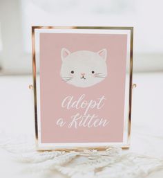 a pink card with a white cat on it and the words custom sign in gold frame