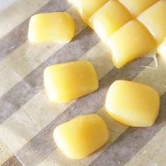 four pieces of butter sitting on top of a piece of wax paper next to each other