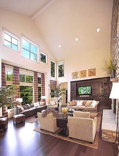 a large living room filled with furniture and a fire place in the middle of it