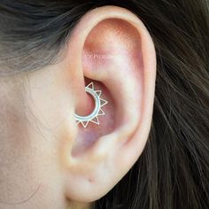 an ear with a star and moon design on it