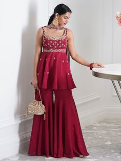 A three-piece Aaisha Sharara set from the Rashika Sharma collection. This beautiful maroon peplum kurta in chiffon fabric is paired with a chiffon sharara pant. The outfit is completed with a georgette choker dupatta. The sequins, nakshi, pechani, pearl and mirror work enhance the Aaisha sharara set. Potli Bag NOT included. Chiffon Sharara, Choker Dupatta, Kurta And Sharara Set, Brother Wedding, Kurta And Sharara, Sharara Designs, Sharara Pants, Indian Dresses Traditional, Traditional Indian Outfits