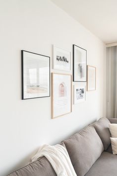 a living room filled with furniture and pictures on the wall above it's couch