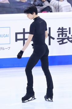 a male figure skating on an ice rink