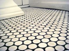 a white toilet sitting on top of a tiled floor