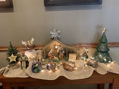 a nativity scene is displayed on a table