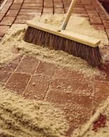 a broom is being used to clean bricks