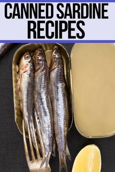 there are three sardines in a tin with lemon wedges next to it