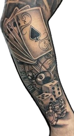 a man's arm covered in tattoos with playing cards and dices on it