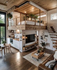 a living room filled with furniture and a fire place next to a staircase leading up to a loft bed