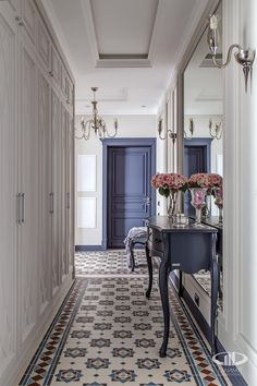 the hallway is decorated in blue, white and pink colors with an ornate table on one side